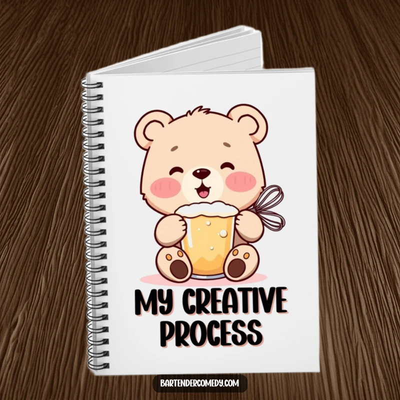 Cheerful bear cub mixing a frothy drink with a whisk on the cover of this whimsical notebook.